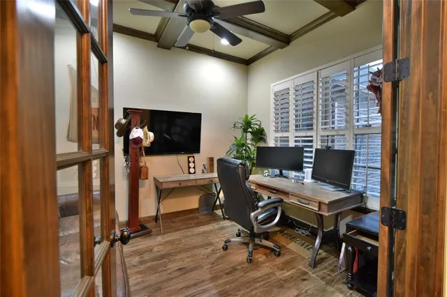 a view of a workspace with furniture and a window