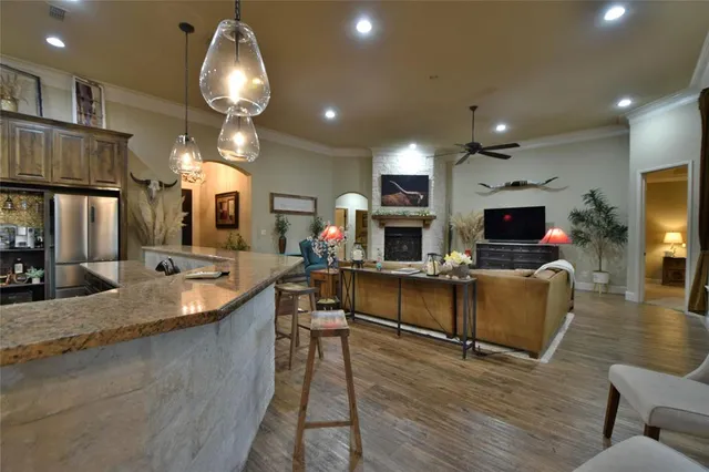 a kitchen with counter top space and living room view