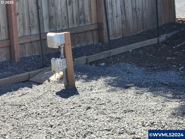 a backyard of a house with table and chairs
