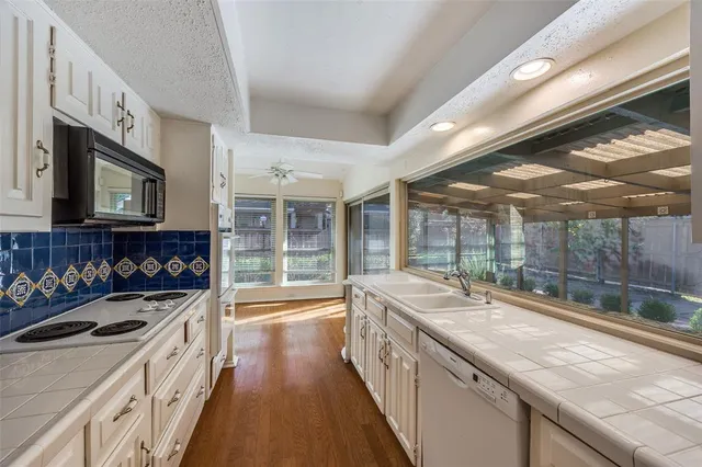 a kitchen that has a sink and a stove