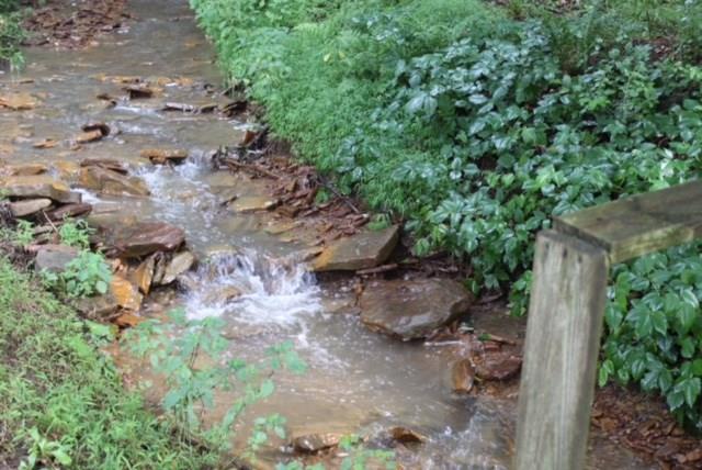 471 County Road Slickville, PA 15684 - Photo 22 of 25 A small stream runs between the home and the large outbuilding.