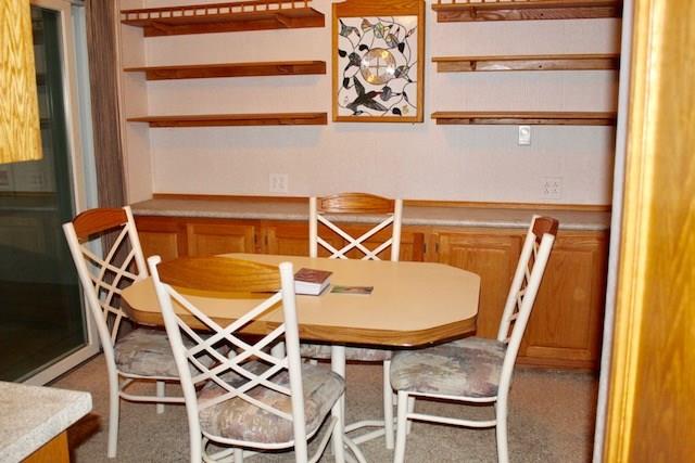 471 County Road Slickville, PA 15684 - Photo 5 of 25 Dining room with shelving and built in storage; matches with the cabinetry of the kitchen.