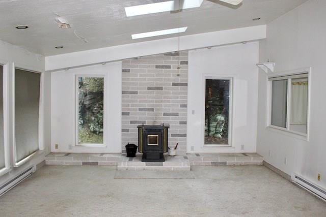 471 County Road Slickville, PA 15684 - Photo 7 of 25 Family room with vaulted ceilings, skylights and pellet stove. Sliders to a patio, and large windows to enjoy all nature has to offer.