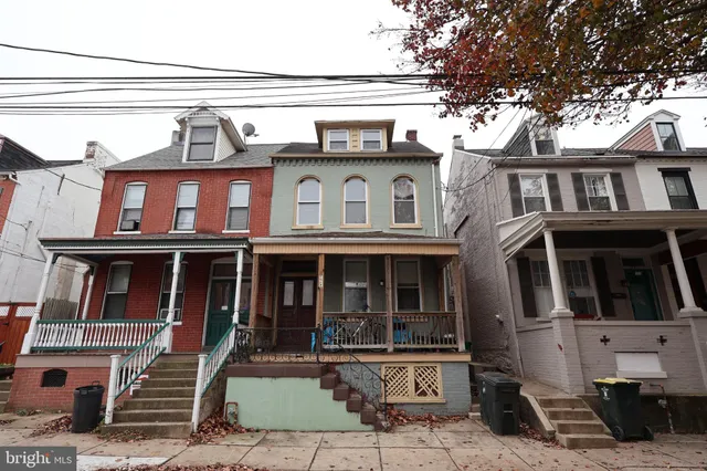 a view of a brick house with large windows