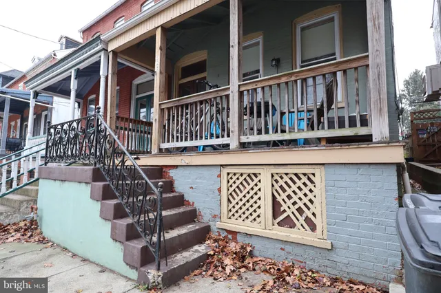 a view of a house with wooden deck