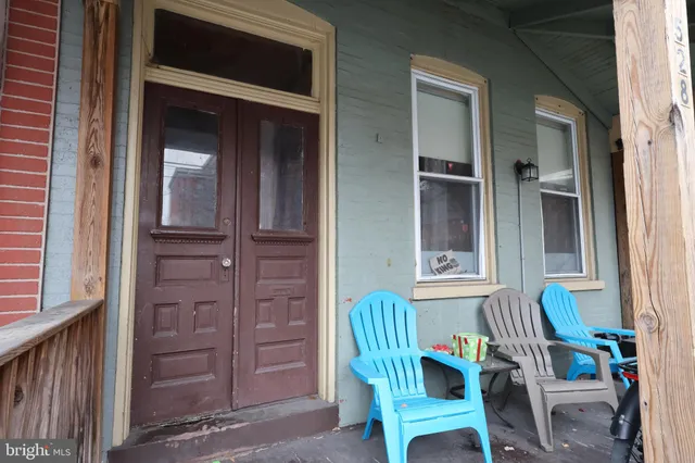 a view of a balcony with chair and front door