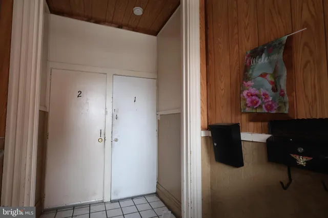 a view of a hallway with wooden floor and furniture