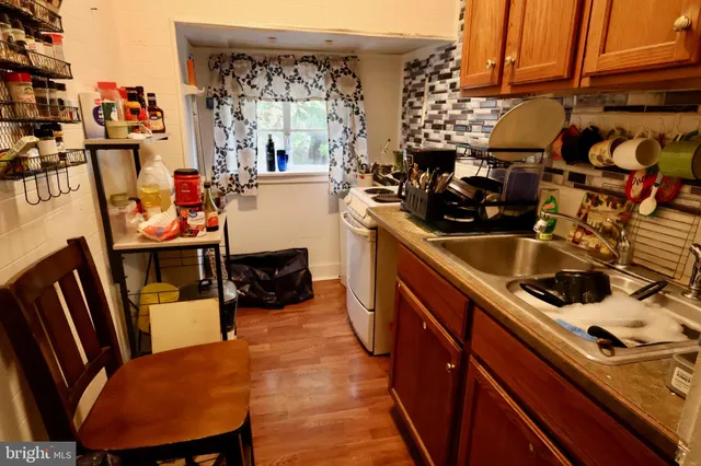 a kitchen with wooden cabinets and a sink