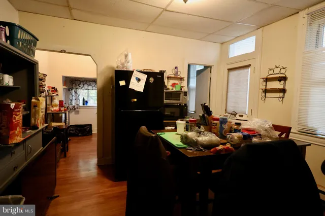 a living room with lots of clothes and shoes