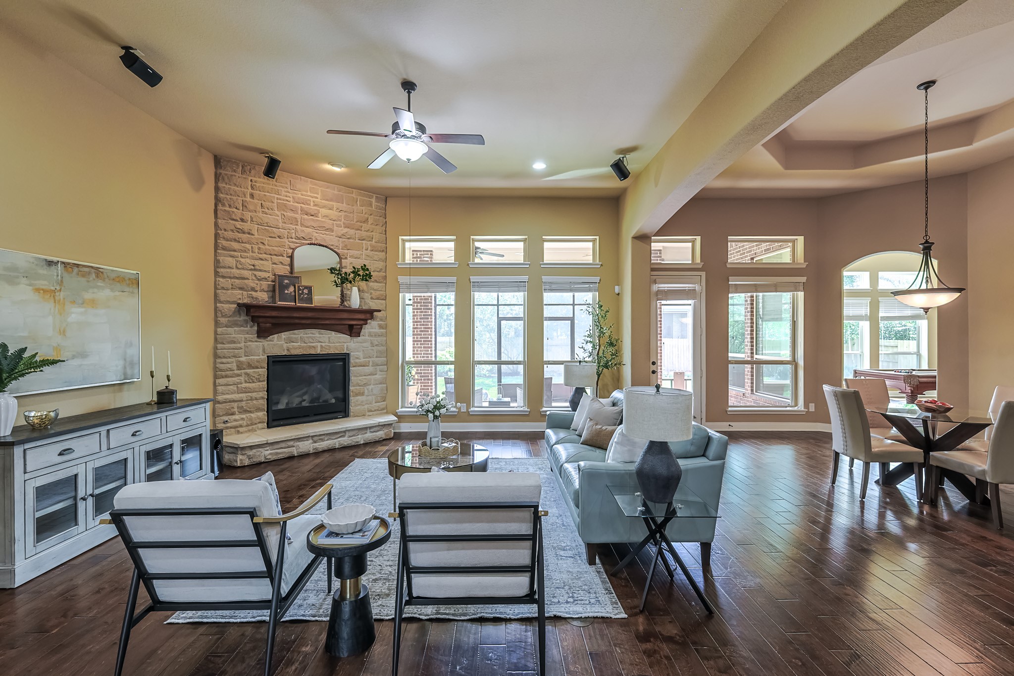 515 Mill Creek Road Pinehurst, TX 77362 - Photo 13 of 48 This spacious living area features elegant finishes and warm wood floors that create a welcoming atmosphere perfect for relaxation and entertaining.