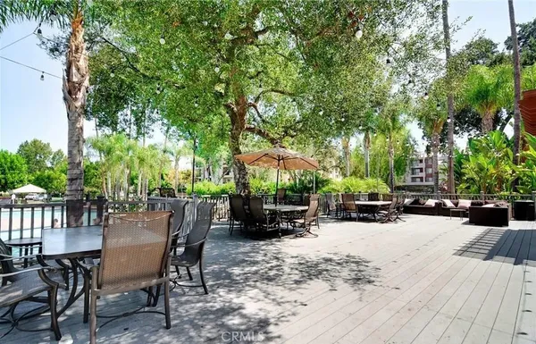 a view of a patio with a table and chairs and a barbeque