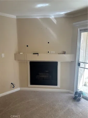 a room with a fireplace and window