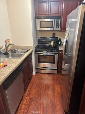 a kitchen with a stove and a refrigerator
