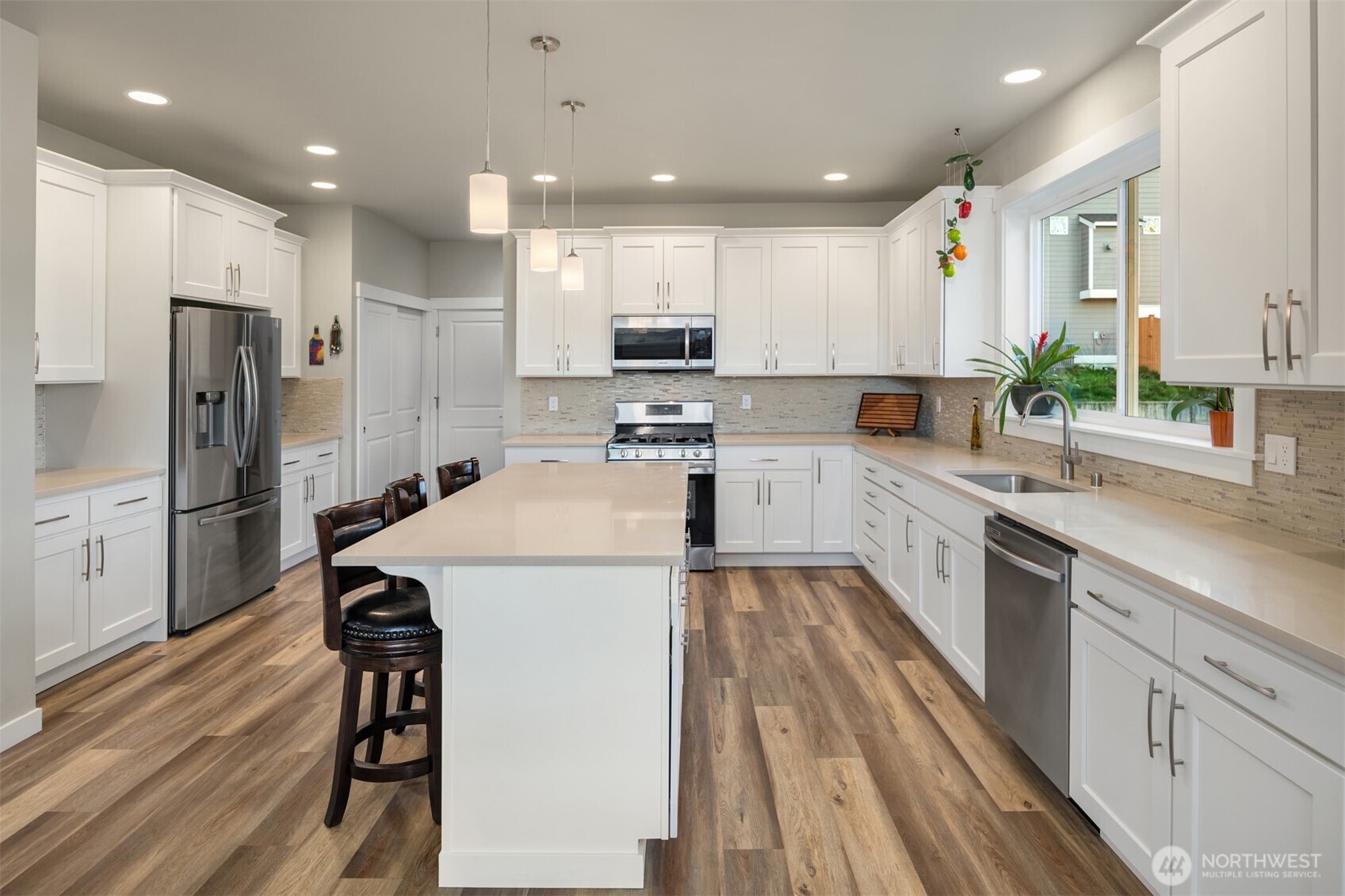 20927 60th Street Southeast Snohomish, WA 98290 - Photo 10 of 40 a kitchen with a sink a refrigerator and a stove top oven