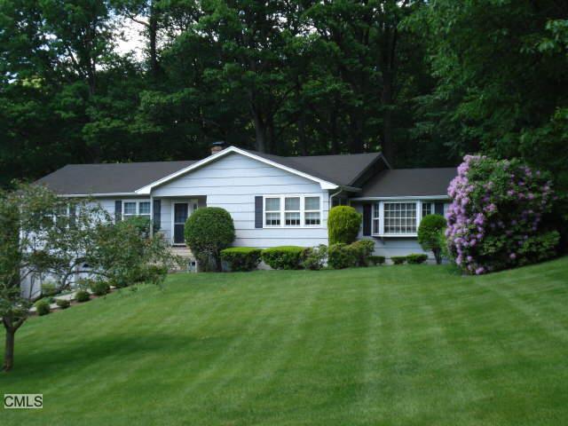 115 Oldfield Road Trumbull, CT 06611 - Photo 1 of 1 a front view of a house with a garden