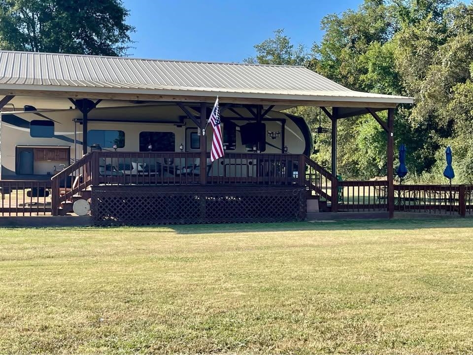 3000 Bridgeview Lane Crump, TN 38327 - Photo 2 of 6 a view of a swimming pool with deck and a yard