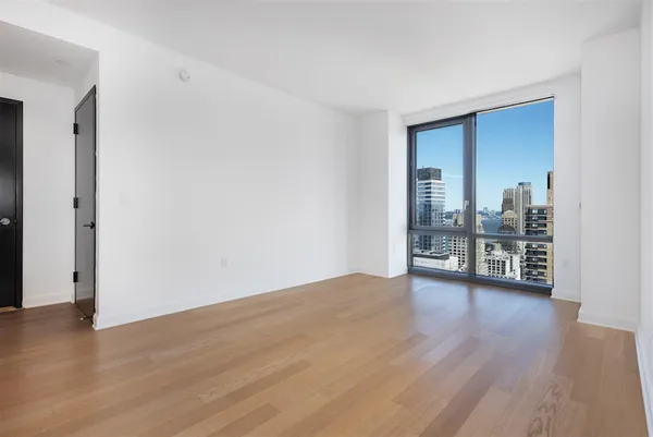 a view of a room with wooden floor