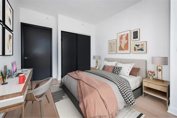 a bedroom with a bed and a chandelier