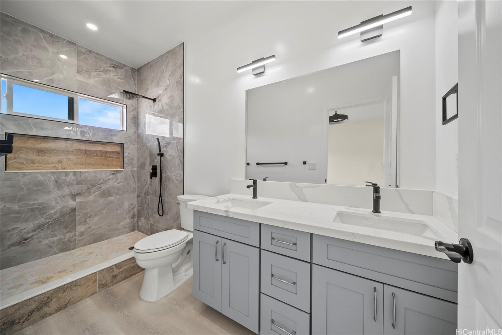 92-792 A Ahikoe Street Kapolei, HI 96707 - Photo 17 of 25 a bathroom with a double vanity sink toilet mirror and shower