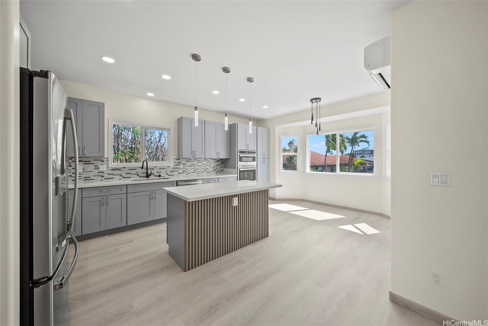 92-792 A Ahikoe Street Kapolei, HI 96707 - Photo 6 of 25 a kitchen with kitchen island sink refrigerator and cabinets