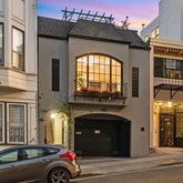 a couple of cars parked in front of a building