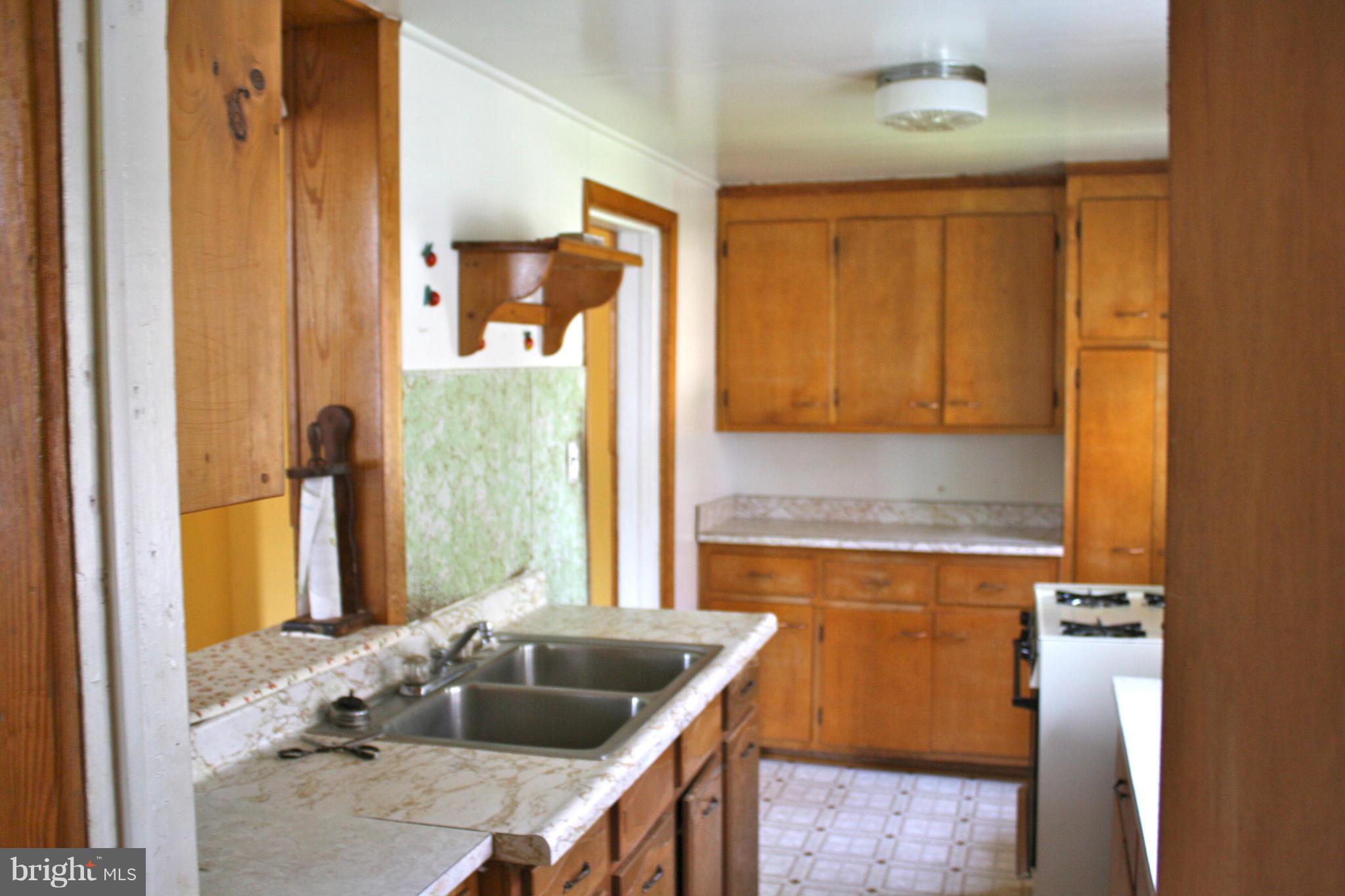 4622 East Joppa Road Perry Hall, MD 21128 - Photo 10 of 29 a kitchen with a granite countertop sink and a cabinets