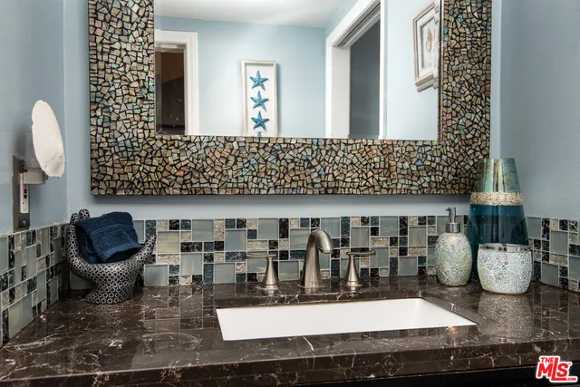 a table with wine bottles and glasses on it