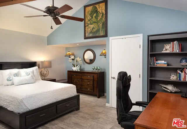 a bedroom with a bed and cabinets