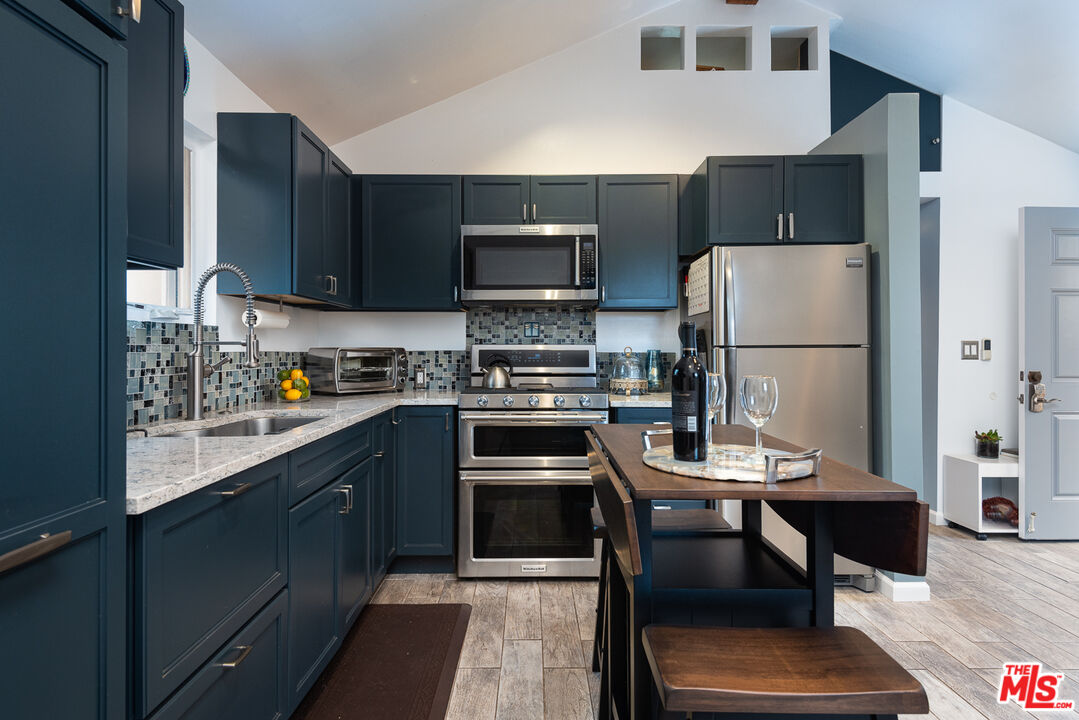 8308 Flight Avenue, Unit ADU Los Angeles, CA 90045 - Photo 3 of 27 a kitchen with a refrigerator a stove a microwave and a dining table