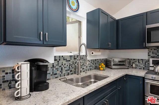 a kitchen with a sink and a refrigerator