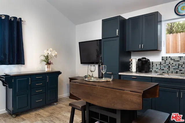 a kitchen with a sink cabinets and window
