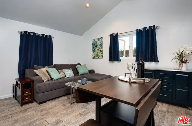 a living room with furniture window and wooden floor