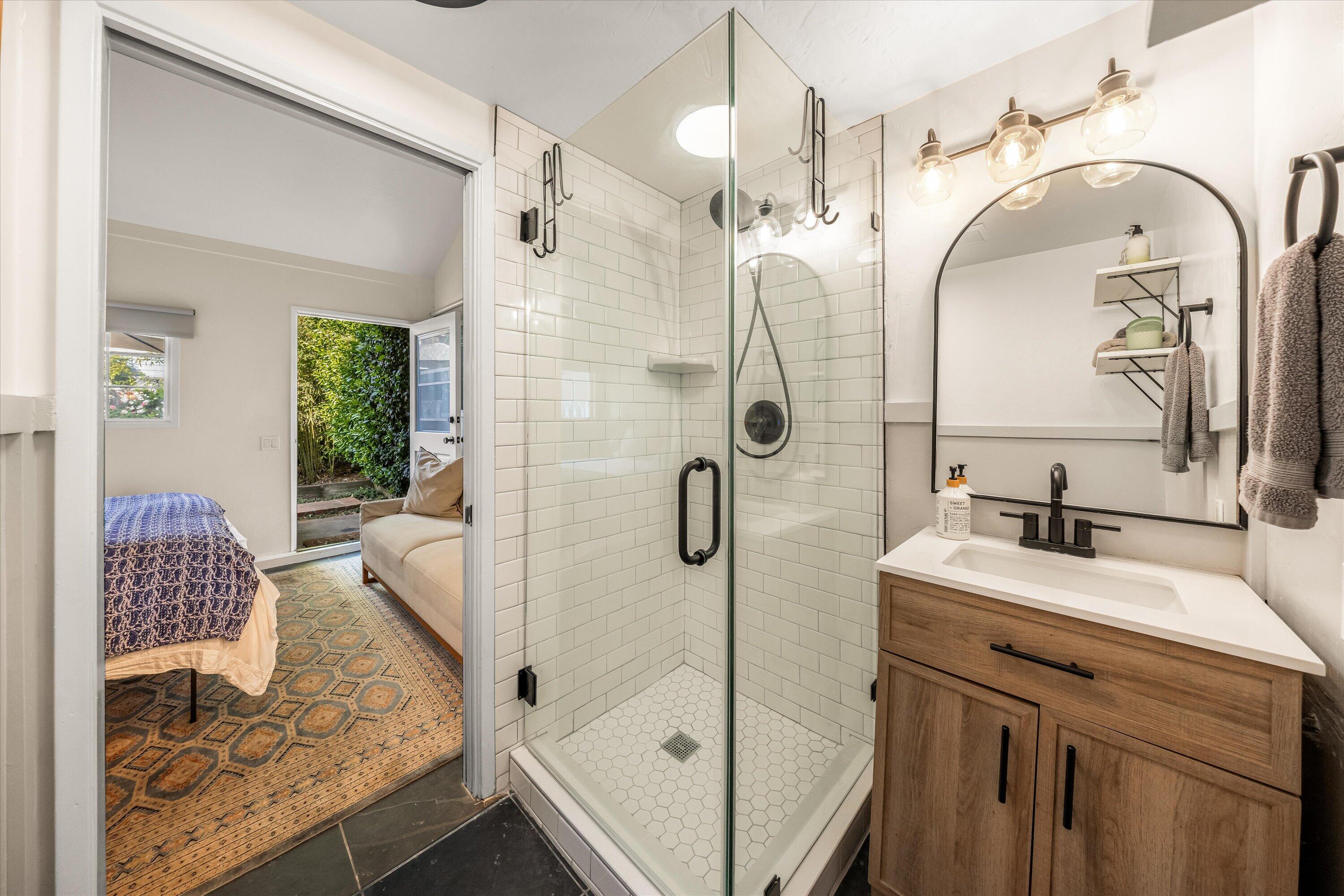 22 East Islay Street Santa Barbara, CA 93101 - Photo 20 of 26 a bathroom with a double vanity sink mirror and shower