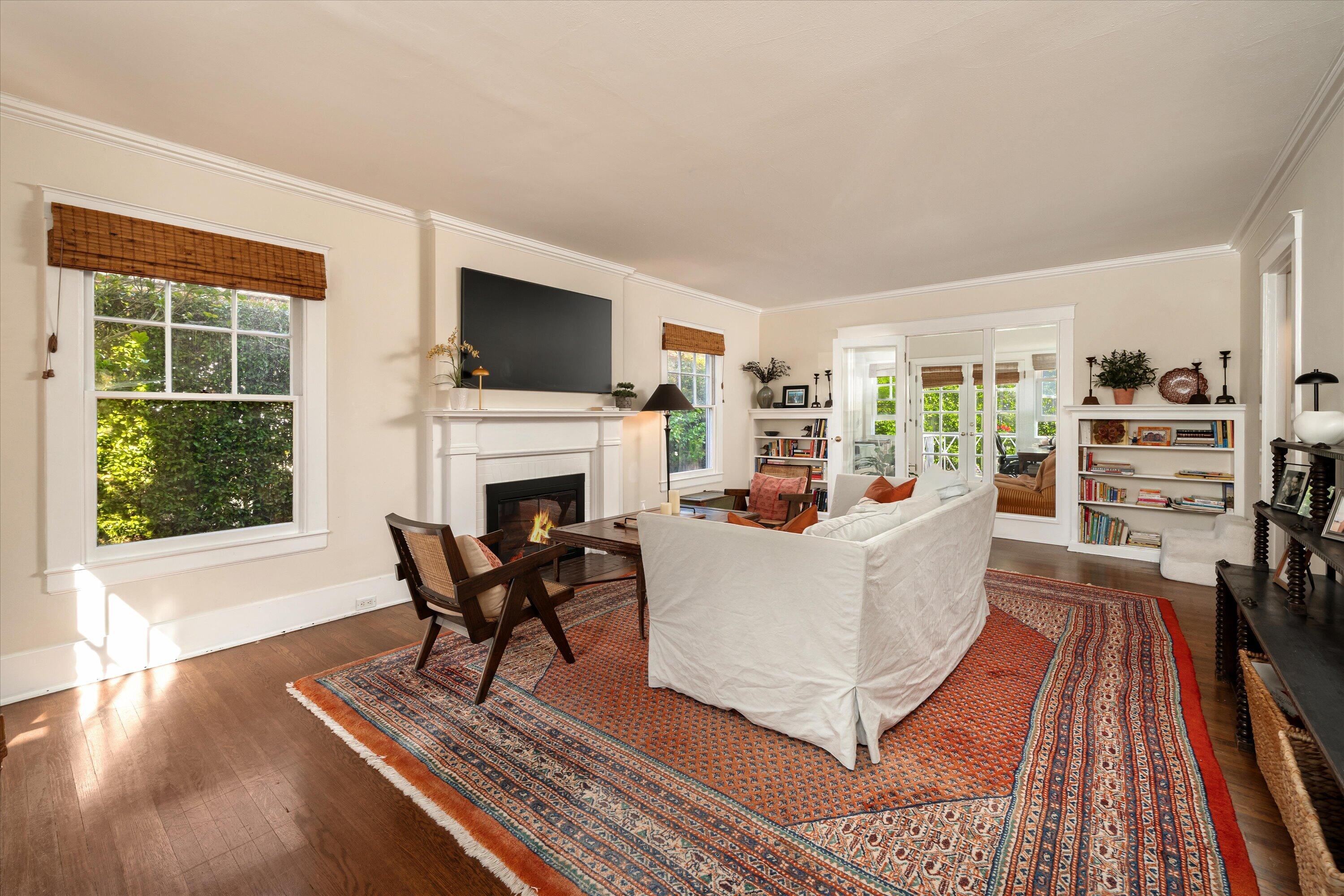 22 East Islay Street Santa Barbara, CA 93101 - Photo 3 of 26 a living room with furniture a flat screen tv and a fireplace