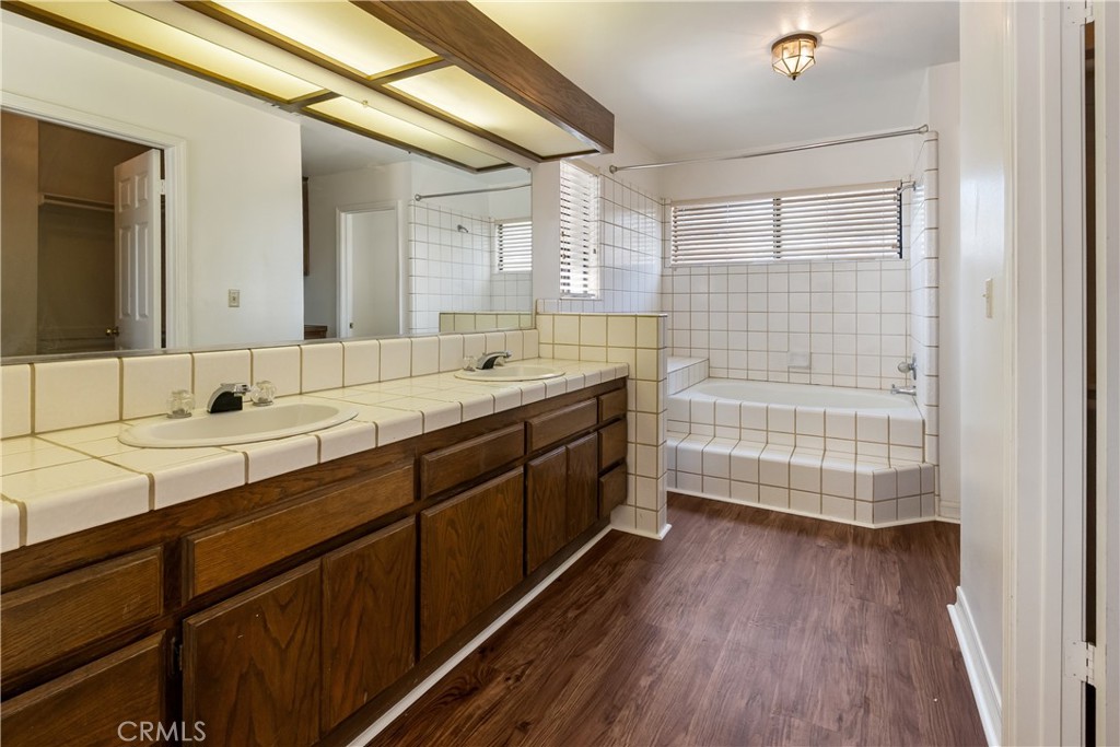 17656 Mockingbird Hill Circle Riverside, CA 92504 - Photo 20 of 49 a spacious bathroom with a double vanity sink a mirror and a shower