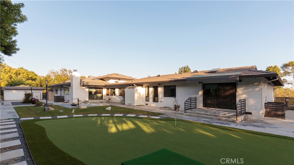 1885 Kashlan Road La Habra Heights, CA 90631 - Photo 26 of 44 Putting green and rear side of the main residence
