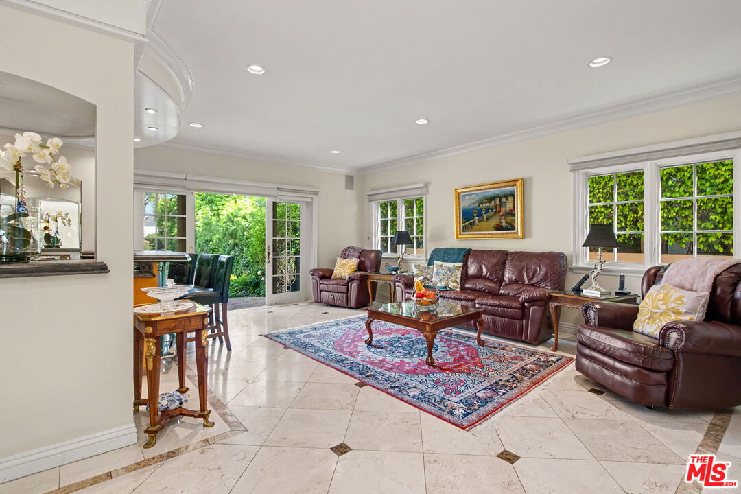 204 Foothill Road Beverly Hills, CA 90210 - Photo 15 of 38 a living room with furniture a rug and a large window
