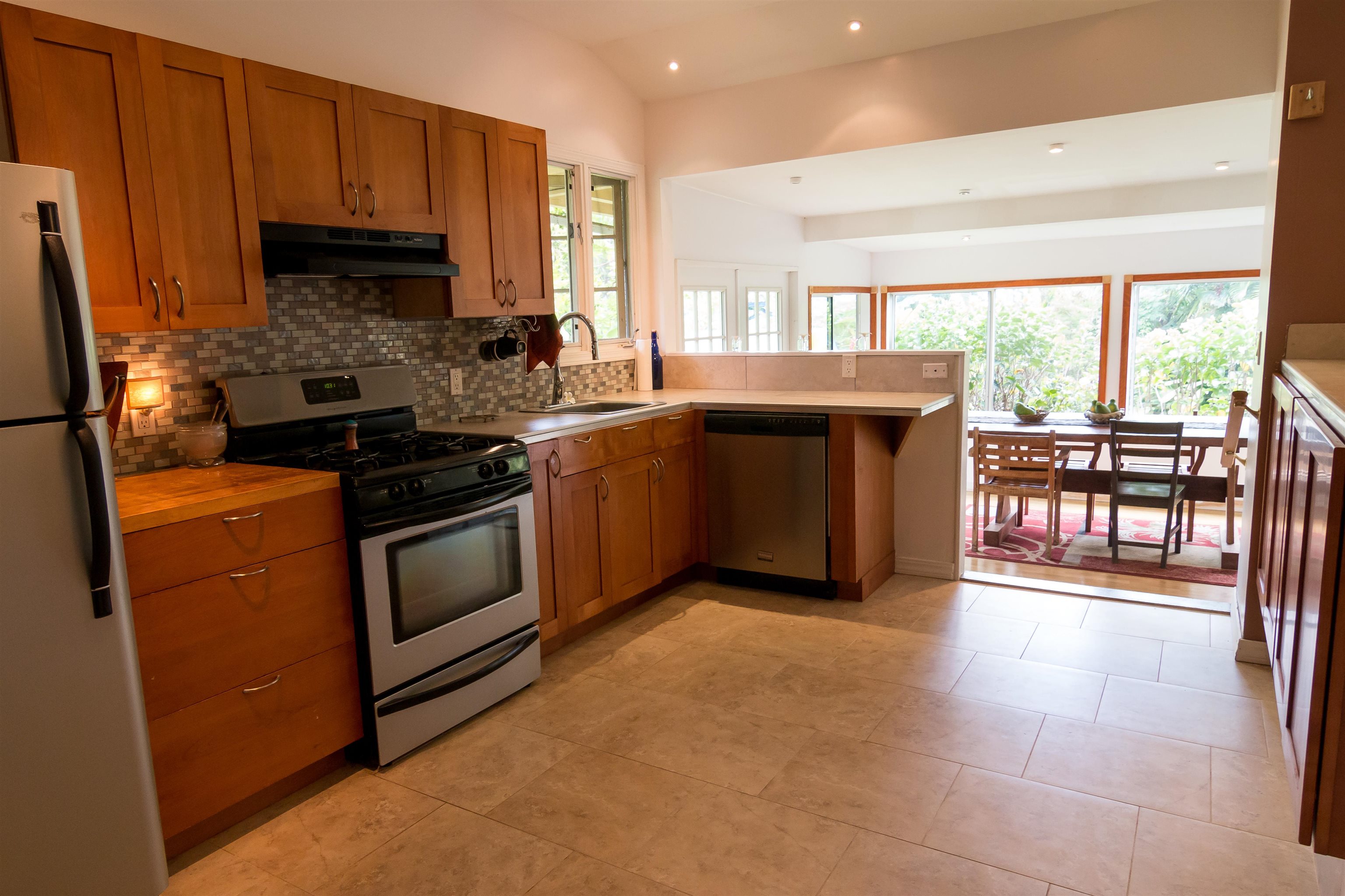3245 Luahine Place Haiku, HI 96708 - Photo 6 of 10 a kitchen with stainless steel appliances granite countertop a stove a sink and a refrigerator