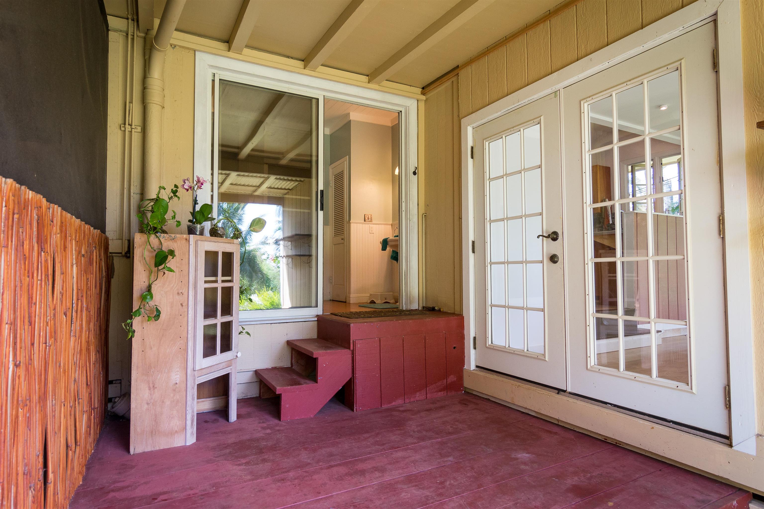 3245 Luahine Place Haiku, HI 96708 - Photo 9 of 10 an empty room with wooden floor and windows
