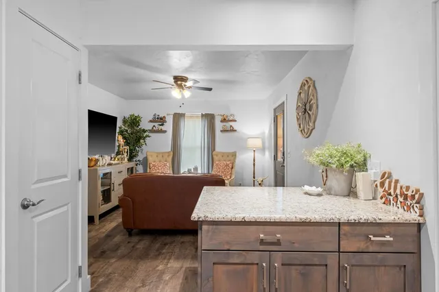 a living room with granite countertop furniture and fireplace