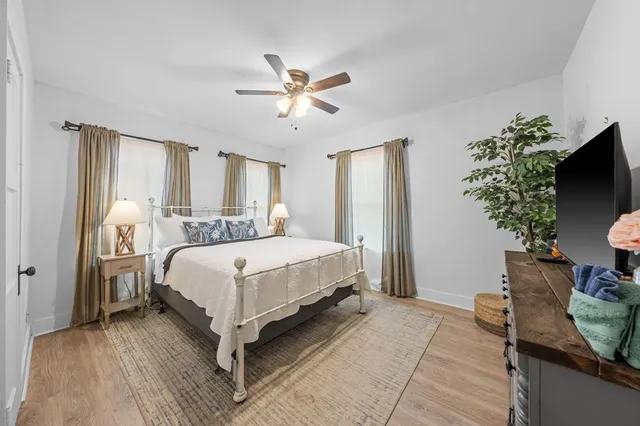 a bedroom with a bed and a potted plant