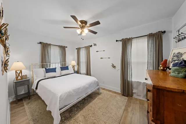 a bedroom with a bed and a chandelier