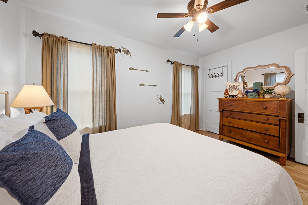 314 West Hackberry Street Fredericksburg, TX 78624 - Photo 19 of 25 a bedroom with a bed and a chandelier