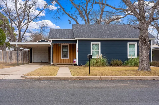 a house that has a tree in front of it