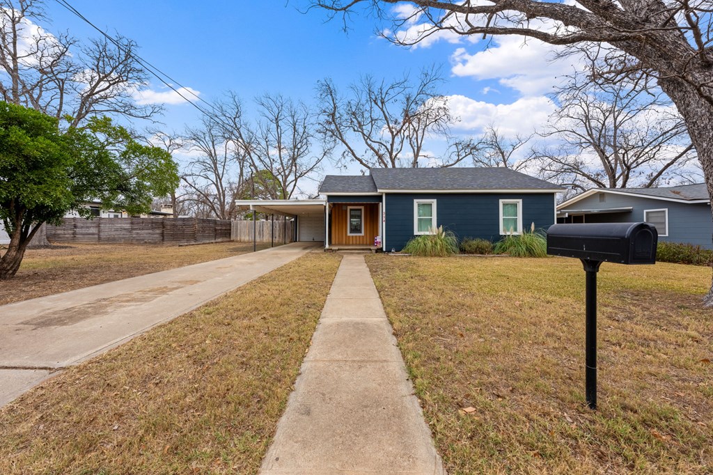 314 West Hackberry Street Fredericksburg, TX 78624 - Photo 5 of 25 a front view of a house with a yard and potted plants