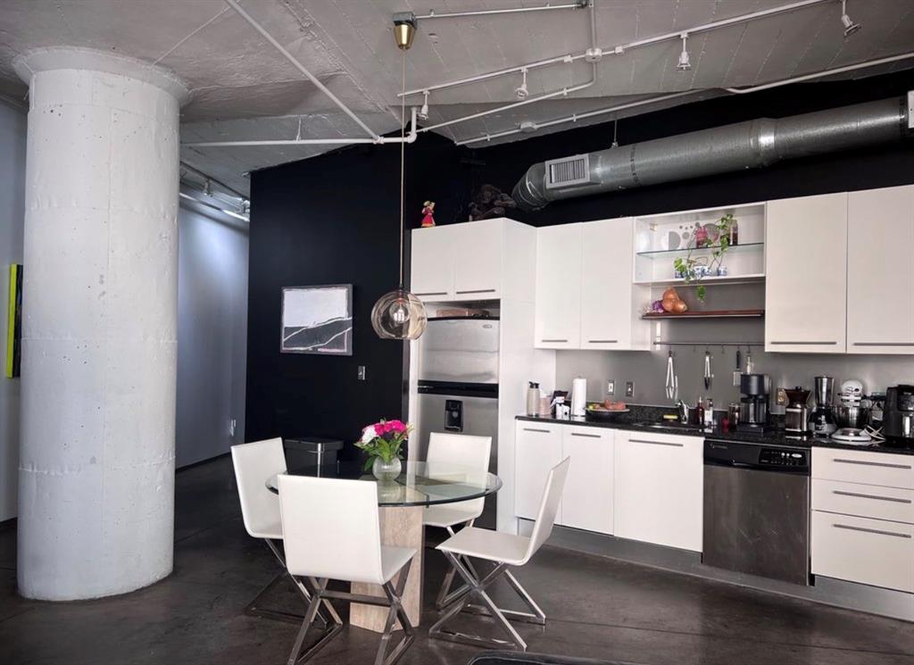 1122 Jackson Street, Unit 514 Dallas, TX 75202 - Photo 20 of 40 Industrial-style kitchen featuring exposed ductwork and a concrete ceiling