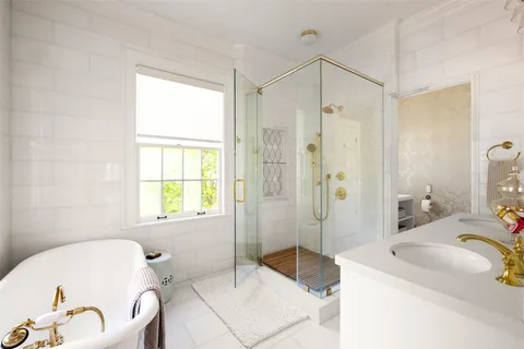 a spacious bathroom with a tub sink shower and a mirror