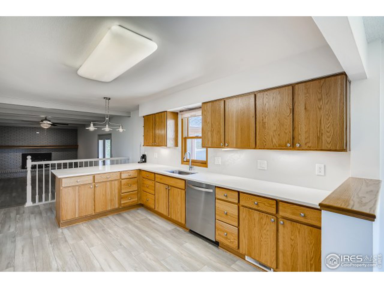 13165 East County Line Road Longmont, CO 80504 - Photo 22 of 39 Kitchen into family room and sunroom entry.