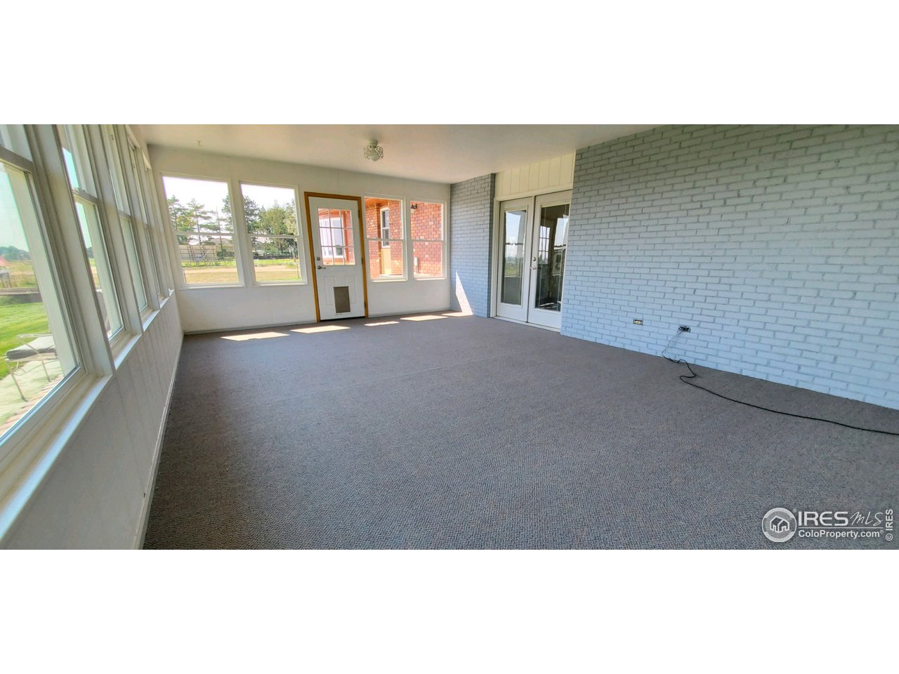 13165 East County Line Road Longmont, CO 80504 - Photo 38 of 39 Sunroom with New Carpet & Paint