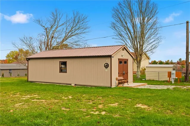 a white house that has a tree in front of it